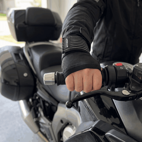 MotoWrap wrist support on a rider's right hand, twisting the throttle and pulling the front brake lever